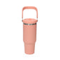 Coral insulated tumbler with a large top handle and a stainless steel ring below the lid on a white background