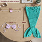Teal crochet mermaid tail and pink shell top shown flat with measurement guides on a wood table