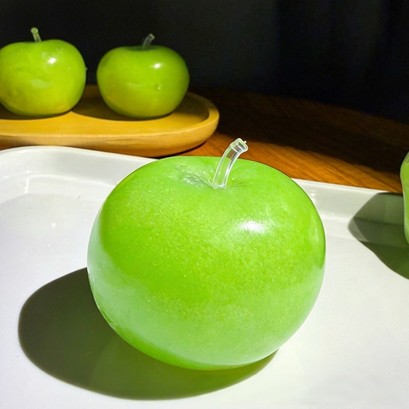 Green apple squishy on a white dish under warm light, icy granular texture through the gel