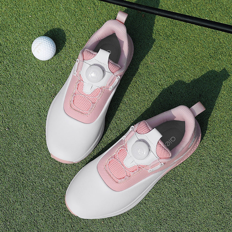 White and pink golf shoe with a twist dial closure and a nubbed spikeless rubber outsole