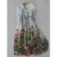 Three quarter sleeve floral art print midi dress with an A line skirt on a hanger