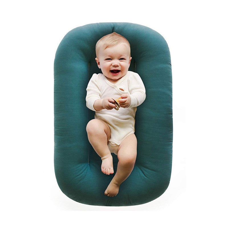 Reference image showing the soft one piece baby lounger nest and its bolster edge