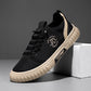 Black lace up canvas sneaker with a beige ribbed sole and heel stripe, leaning on a white block, size EU 43 option