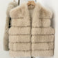 Dark Beige tiered vegan fur sleeveless vest in size S, front view on a wooden hanger