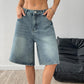 Detail of the denim shorts waistband and seam shown at close range