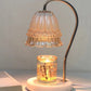 Aromatherapy candle warmer lamp lit on a bedside table
