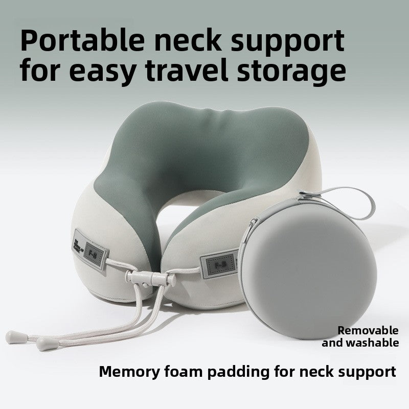 Sage green and cream U shaped neck pillow beside a round gray storage box, adult size, cloth storage box option