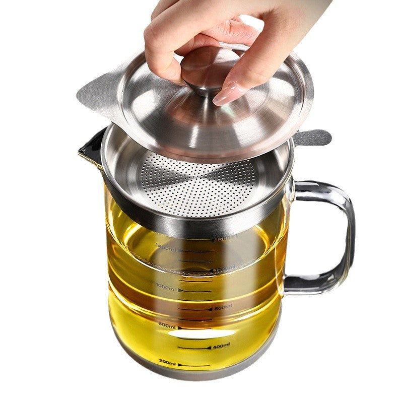 Hand lifting the stainless cover off the strainer basket on top of the glass oil jug