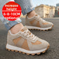 Man in beige and tan suede low top sneakers with a camel side panel and gum sole on asphalt