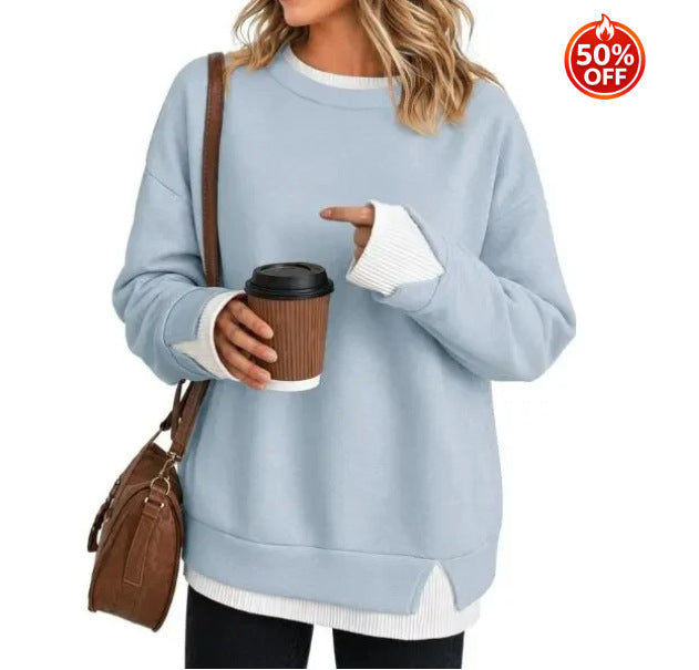 Gray women's sweatshirt showing the split hem and contrast white rib detail