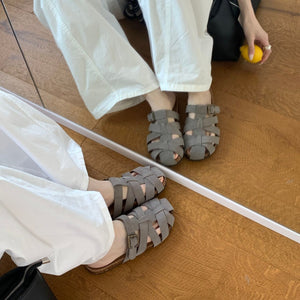 Woven slide sandals side profile showing the open back and buckle