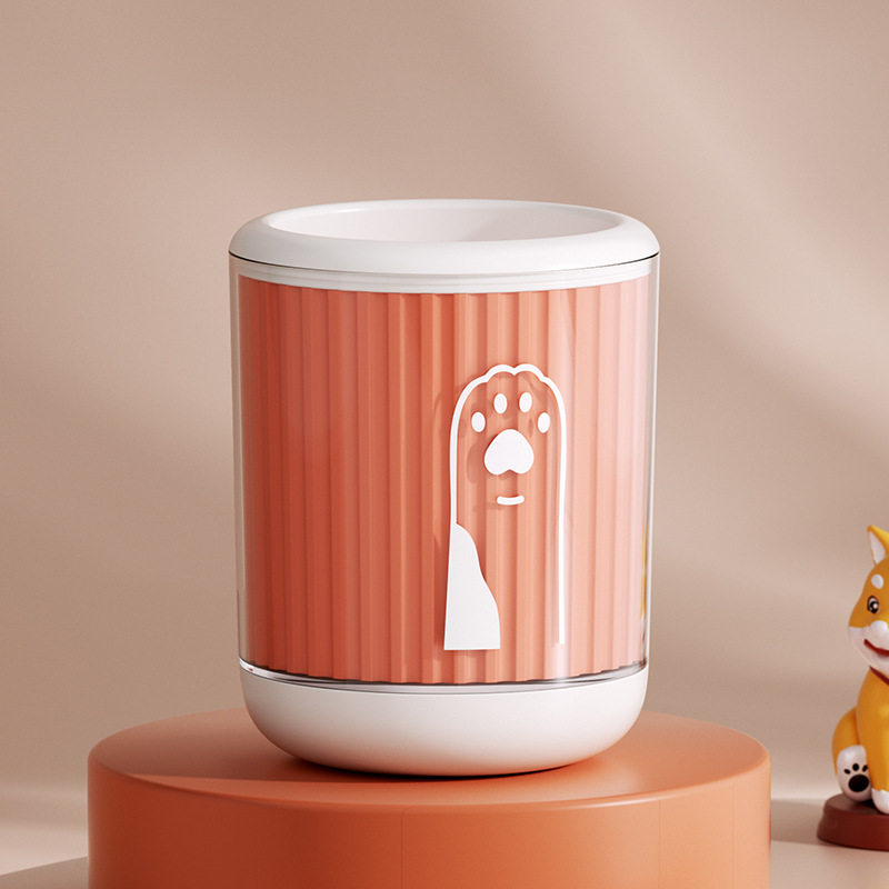 Orange pet paw wash cup with a white paw print graphic, small size, on a studio pedestal
