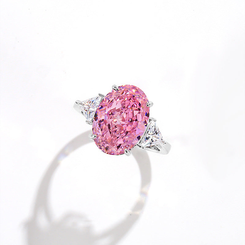 Oval pink simulated diamond on a twisted rope style band with pave accents and a 925 stamp