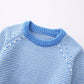 Striped knit women's sweater side angle showing relaxed fit and ribbed cuff detail