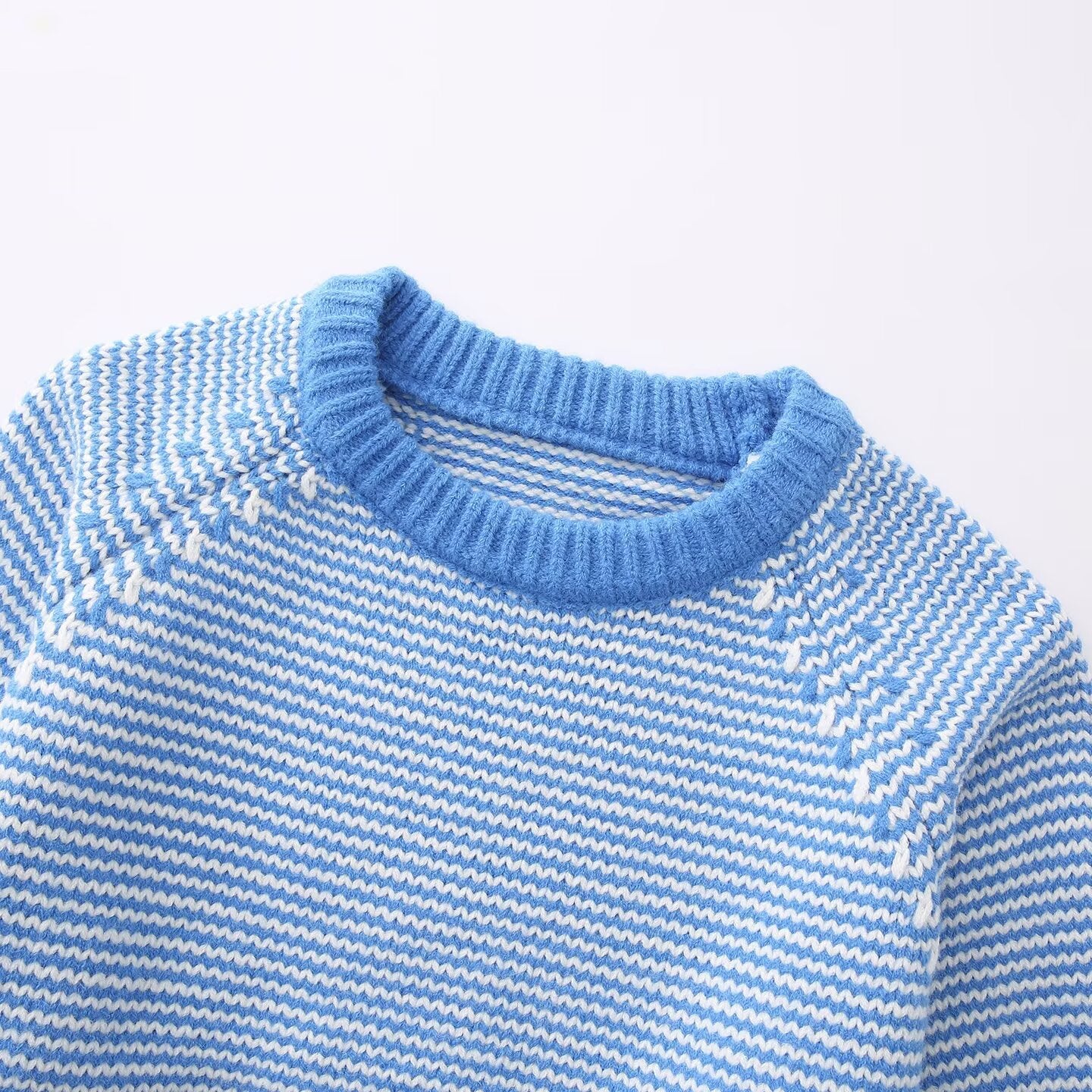 Striped knit women's sweater side angle showing relaxed fit and ribbed cuff detail
