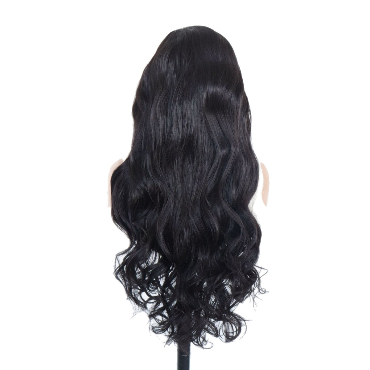 Back view of a long black synthetic wig with loose rolling waves on a white background