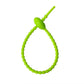 Soft silicone tadpole cable tie coiled into a loop to show the reusable cinch closure