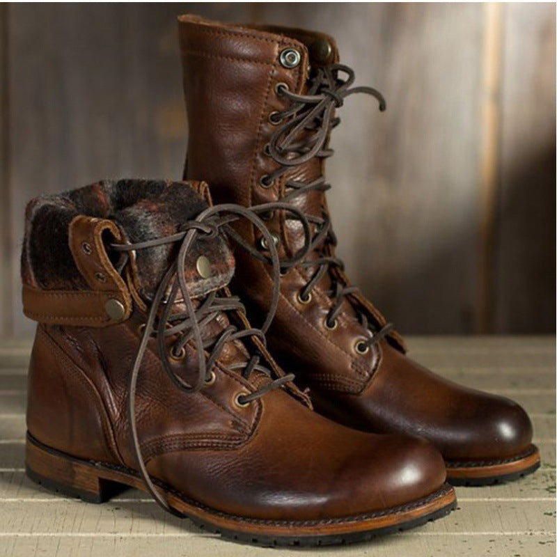 Brown lace-up boots with folded plaid-lined cuff on a wooden background, gallery style photo