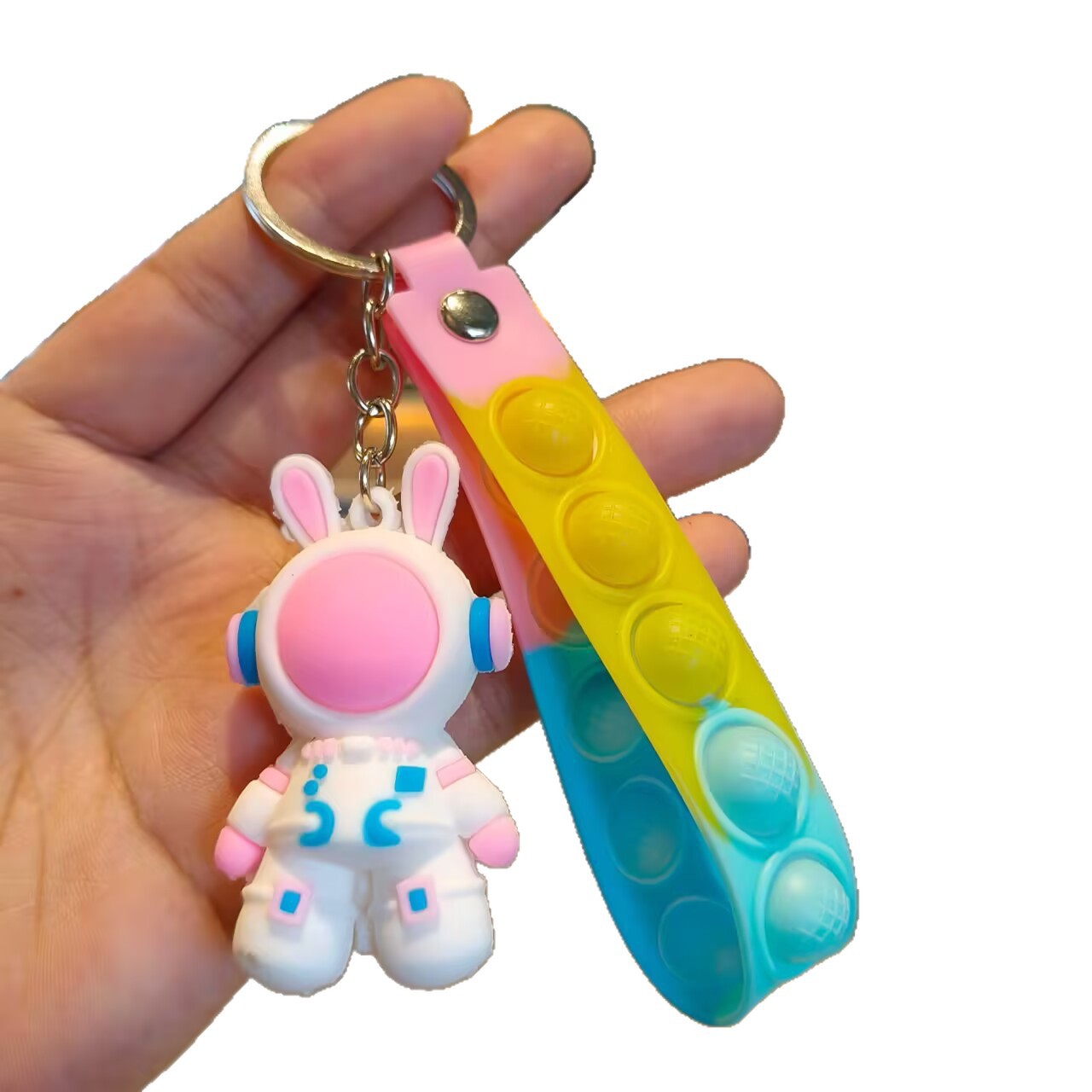 Astronaut rabbit keychain with a molded spacesuit body and long ears on a pastel silicone pop strap