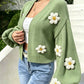 Floral knit cardigan laid to show the open front and cropped hem