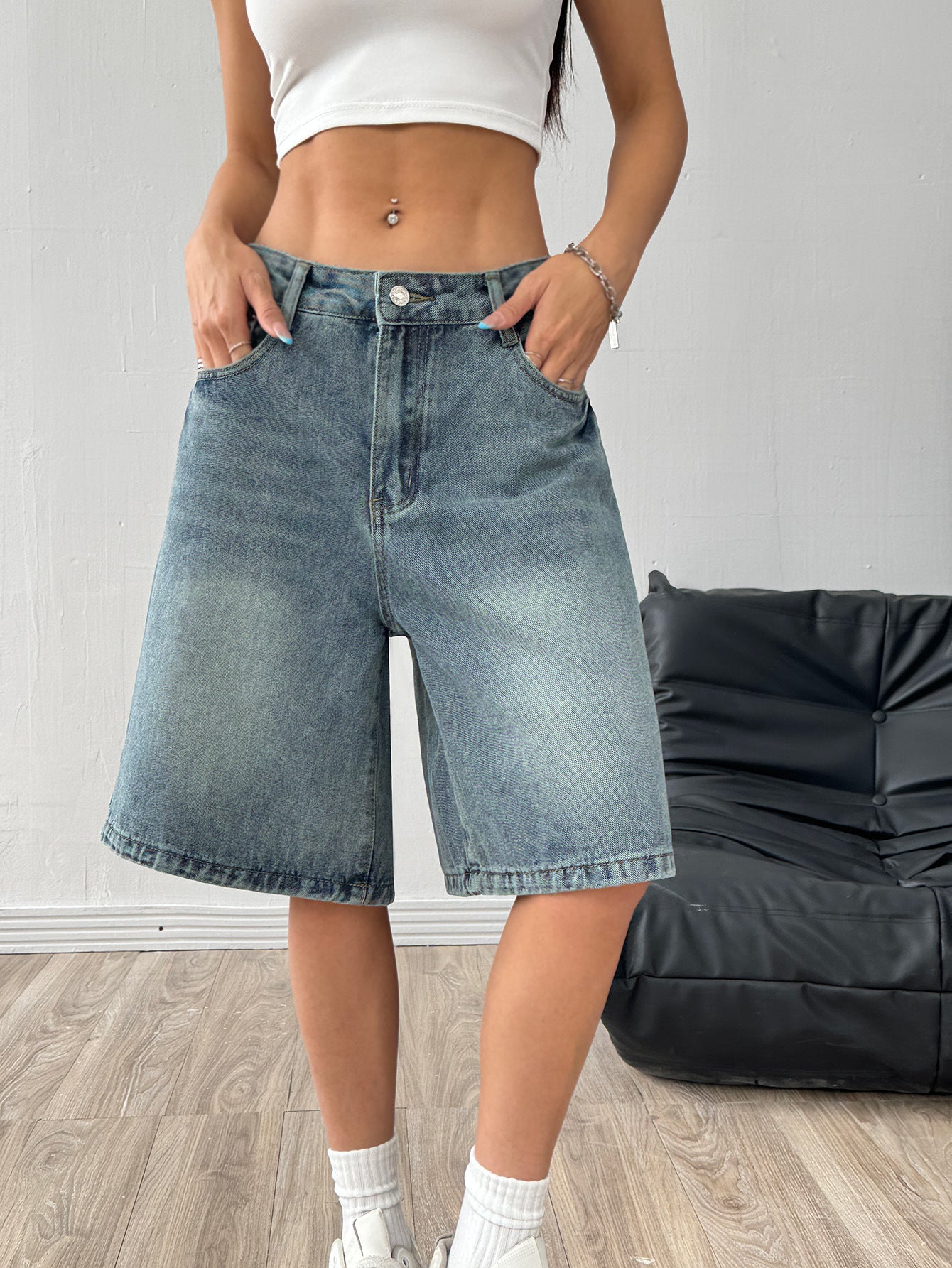 Denim wide-leg shorts folded to show the fixed waistband and clean stitching