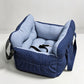Padded car seat pet bed with raised bolster walls, carry handles and an inner clip empty on a car seat showing the raised b
