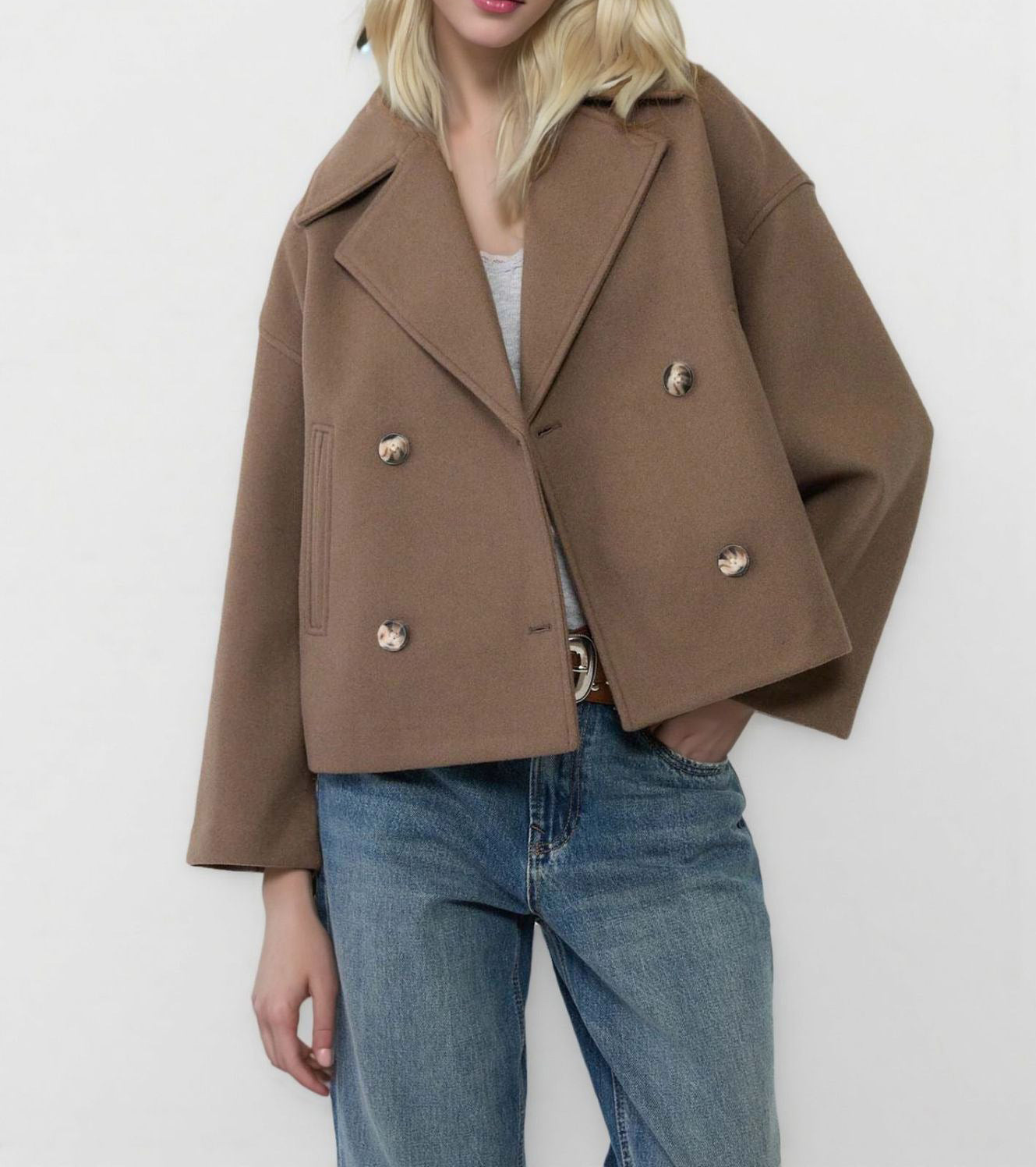 Close view of the notch lapel and double breasted button front of the wool coat
