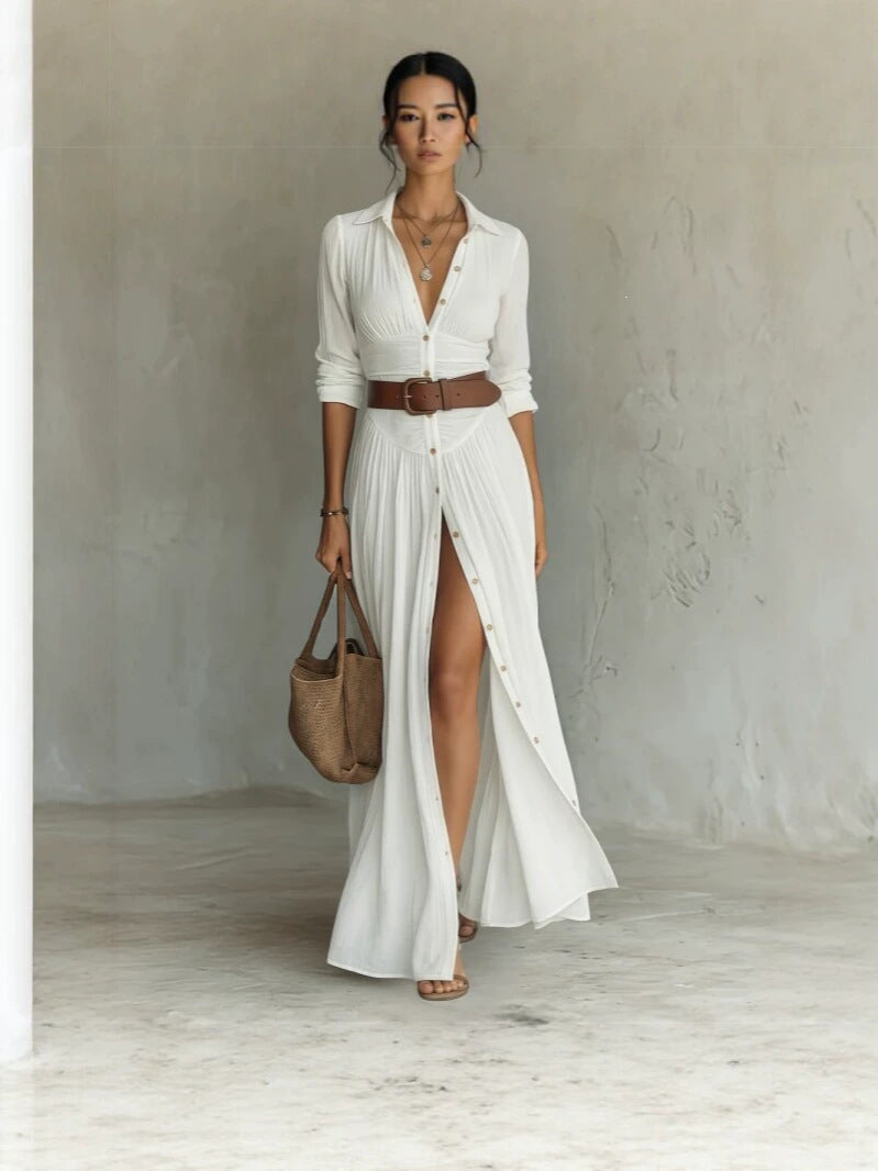 Woman in a white long shirt dress with collar, brown belt and a high front slit, full length front view