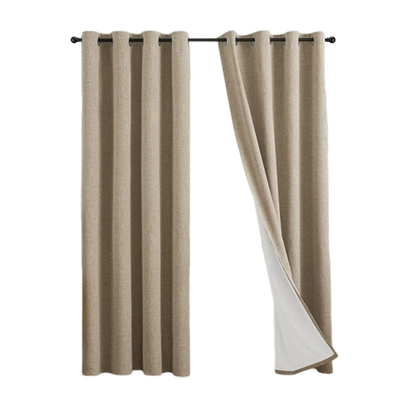 Linen look polyester blackout grommet curtain panel with white thermal backing pleated on a slim black rod over a tall window
