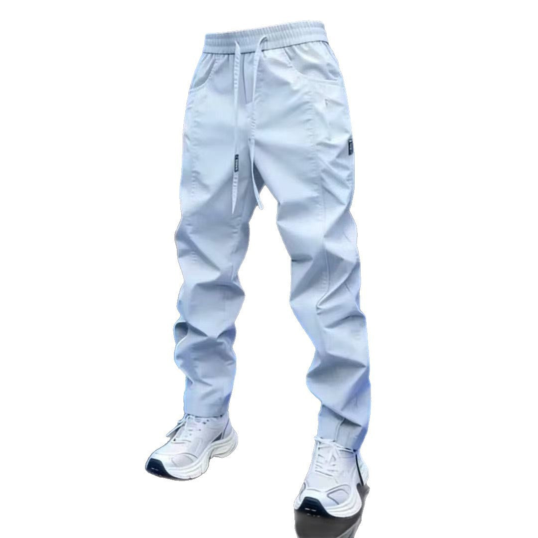 White drawstring jogger pants with white sneakers on a plain white background