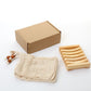 Natural pine soap rack beside a kraft cardboard box and a cream cotton mesh soap bag