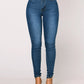Light blue high rise skinny jeans, front view on model with clear heels