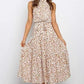 Cream ditsy dot halter neck sleeveless tiered swing maxi dress worn by a model