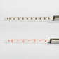 Close view of the two printed scale sticks, one graduated 5 to 50 PSI and one 0.5 to 3.5 kg
