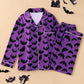 Purple pajama set covered in black bats, button front shirt with piped pocket and pants