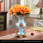 European style resin display piece with pearl shell inlay and gilt scrollwork on a tabletop scene