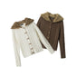Cream white and coffee brown cable knit cardigans with fur trimmed hoods and wooden toggles laid side by side