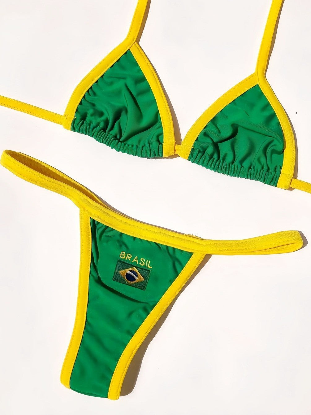Green Brasil bikini flat lay with yellow trim and stitched flag patch