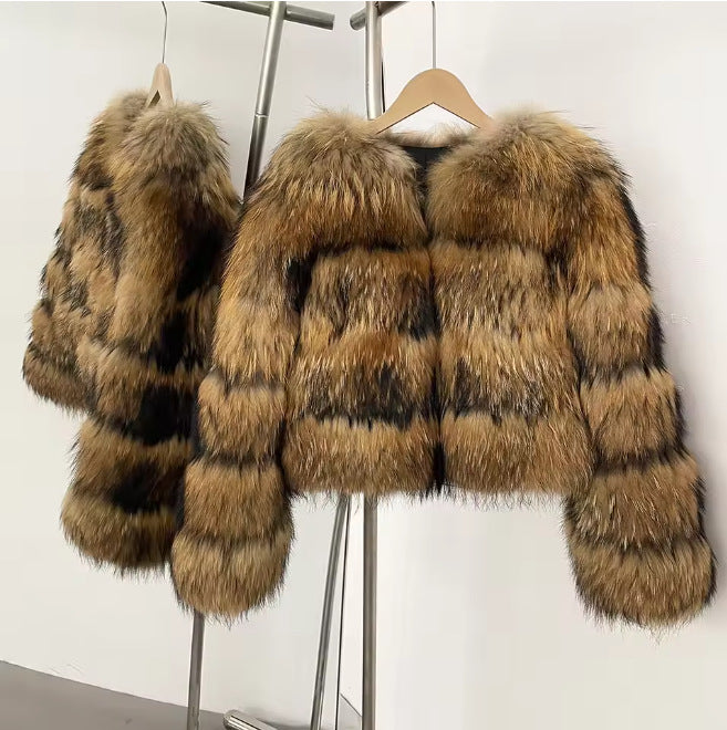 Two cropped banded fur coats in tan and dark brown hanging on a rack