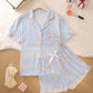 Angled view of the milk silk loungewear set top and ruffle shorts