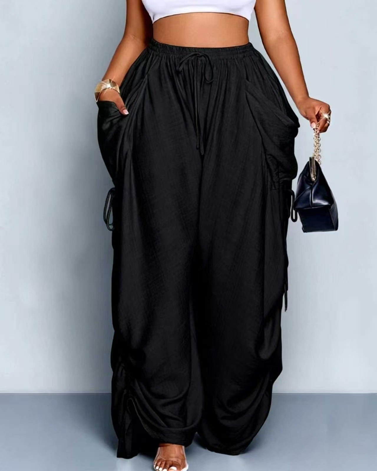 High waist wide leg linen look viscose drawstring trousers, the ruched side ties gathering the outer leg