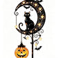 Solar powered Halloween stake light glowing amber along a garden path after dark