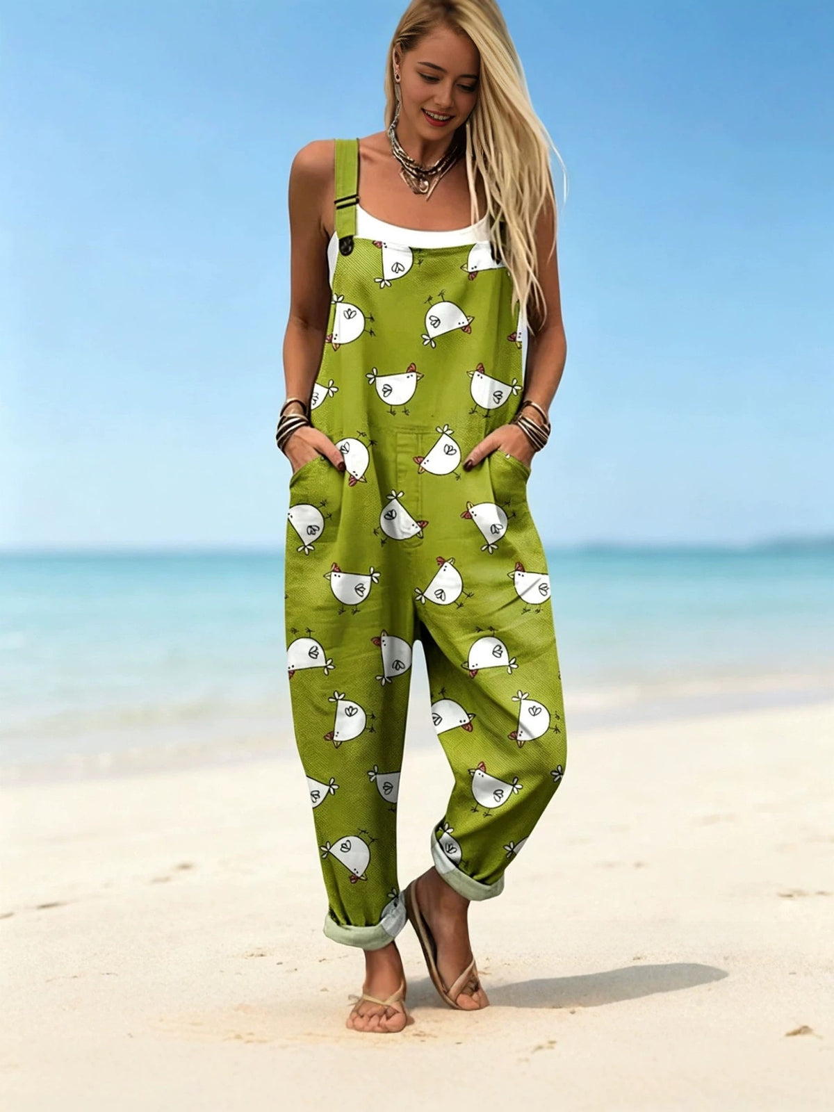 Green fish print bib overalls with side pockets and rolled cuffs worn on a beach, a print not among the listed options