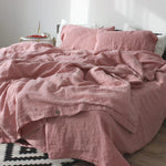 Washed cotton and linen blend bedding set in a soft solid color, styled on a made bed