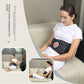 Woman relaxing on a couch with the black inflatable lumbar support belt fitted at the waist