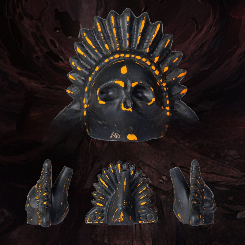 Orange and black ceramic skull death whistle with feather headdress shown with front and side views