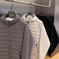 Close view of the quilted padded front panel and centre zip on the hooded jacket