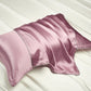 Champagne gold silk pillowcase catching the light on a pale bed