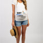 White maternity short sleeve tee with a Baby is Loading print, round neck and side ruching, on a pregnant model
