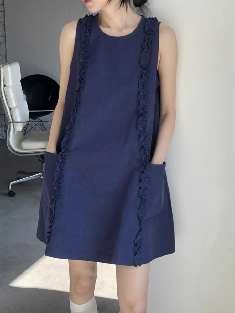 Navy A-line dress showing round neck, ruffle trims and two front patch pockets